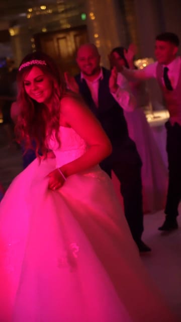 A bride dancing in pink light