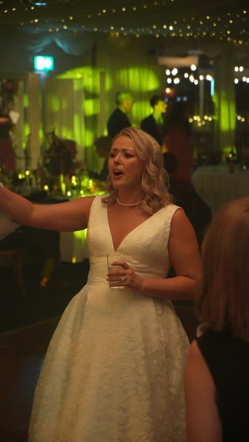 A bride singing along on the dance floor