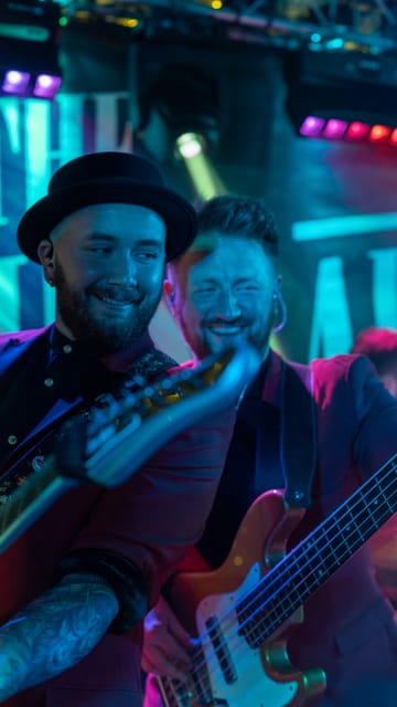 The guitarist and bass player laughing on stage