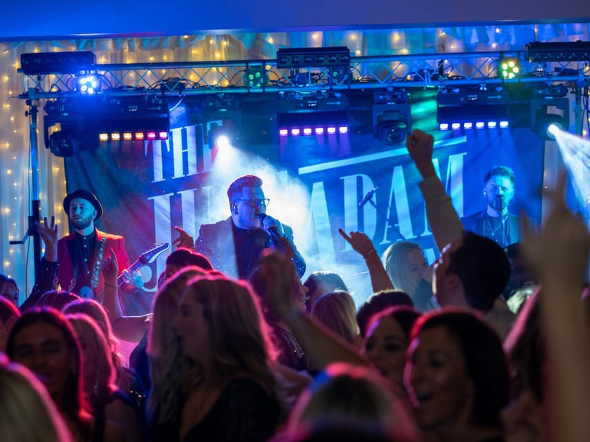 A crowd cheering in front of the band