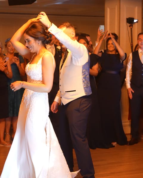 A bride twirled by her groom at Bellingham Castle