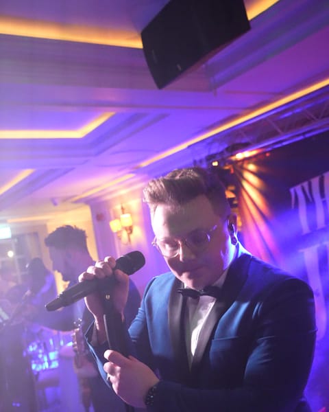 Adam singing on stage at Bellingham Castle