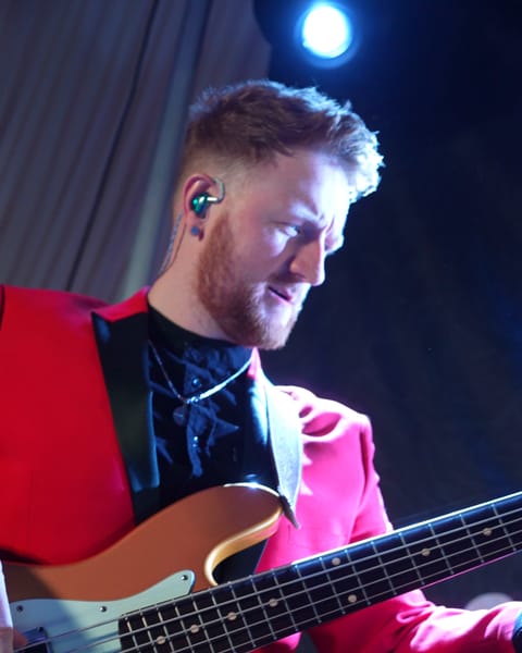 The bass player smiling at La Mon Hotel