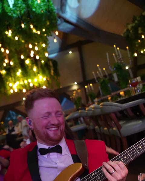 The bass player smiling at The Rabbit Hotel