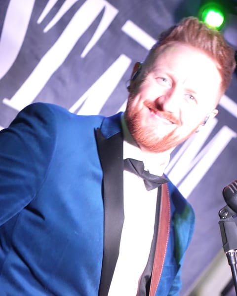 The bass player smiling on stage at Titanic Hotel Belfast