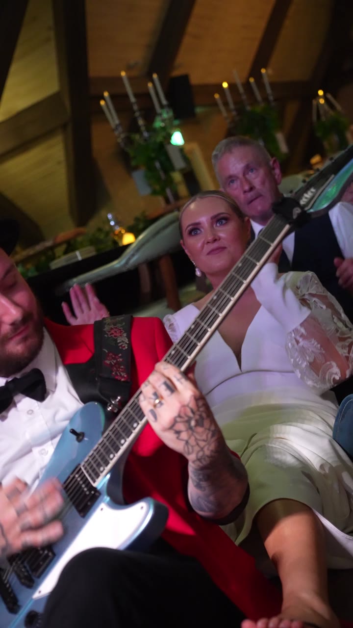 The bride playing the guitar with the band at The Rabbit Hotel